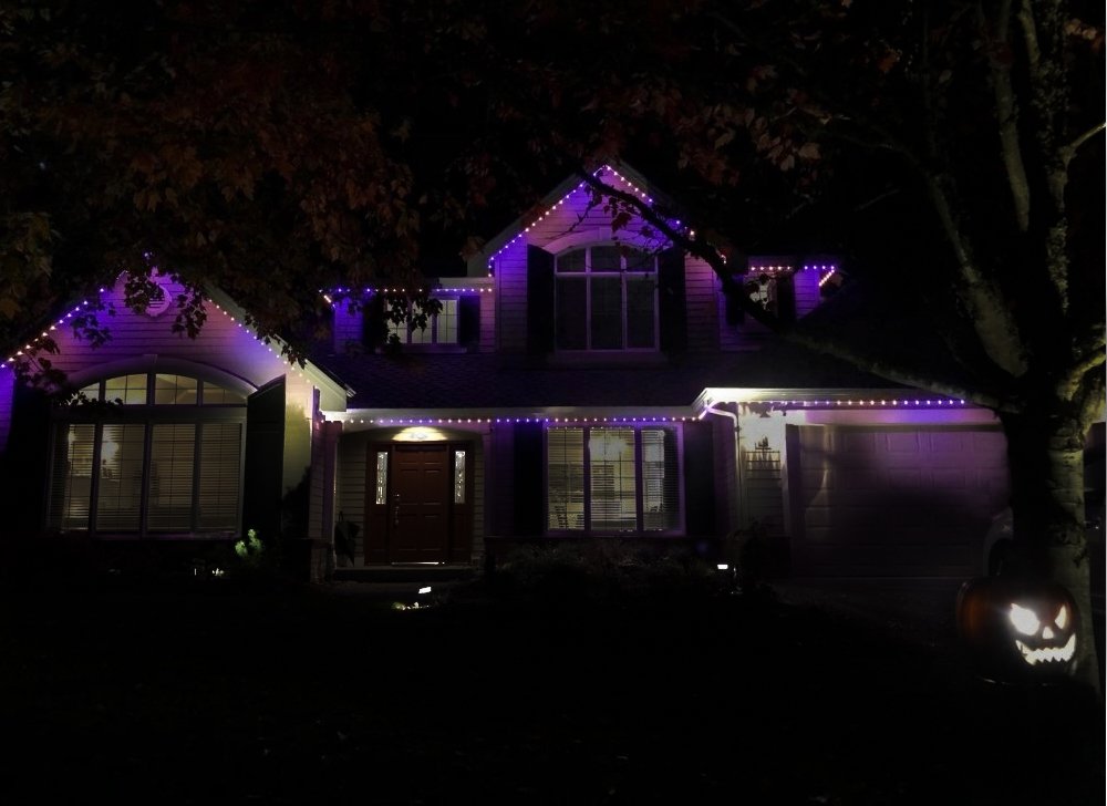 DIY permanent holiday lighting kit on a house with a Halloween theme.