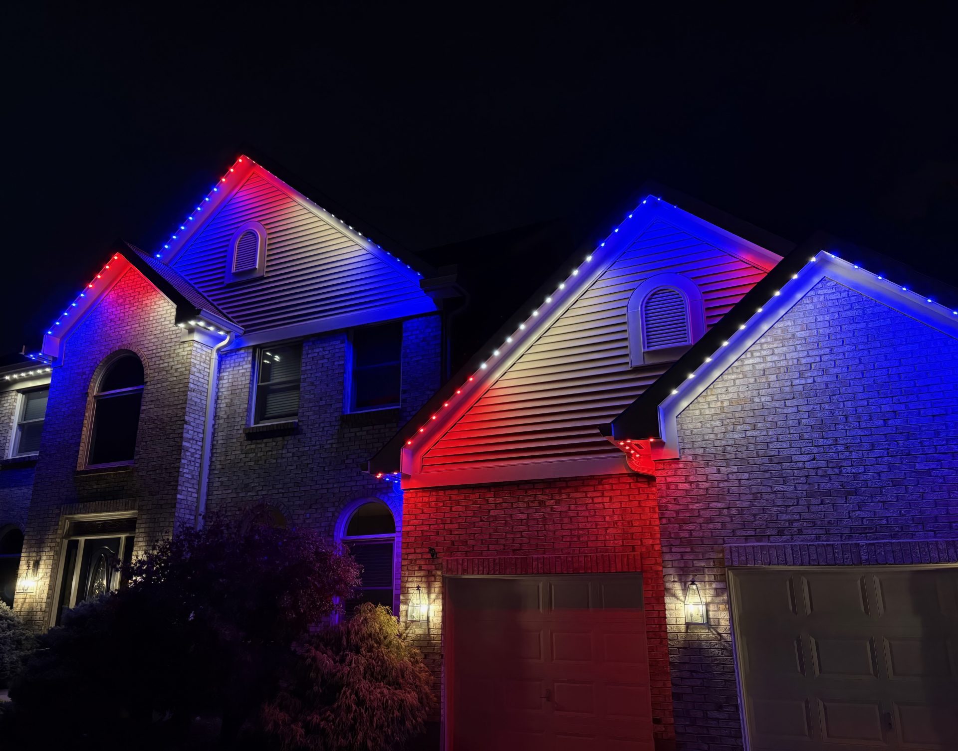 Permanent Outdoor Holiday lights with 30mm LEDs set to a patriotic theme of red, white, and blue.