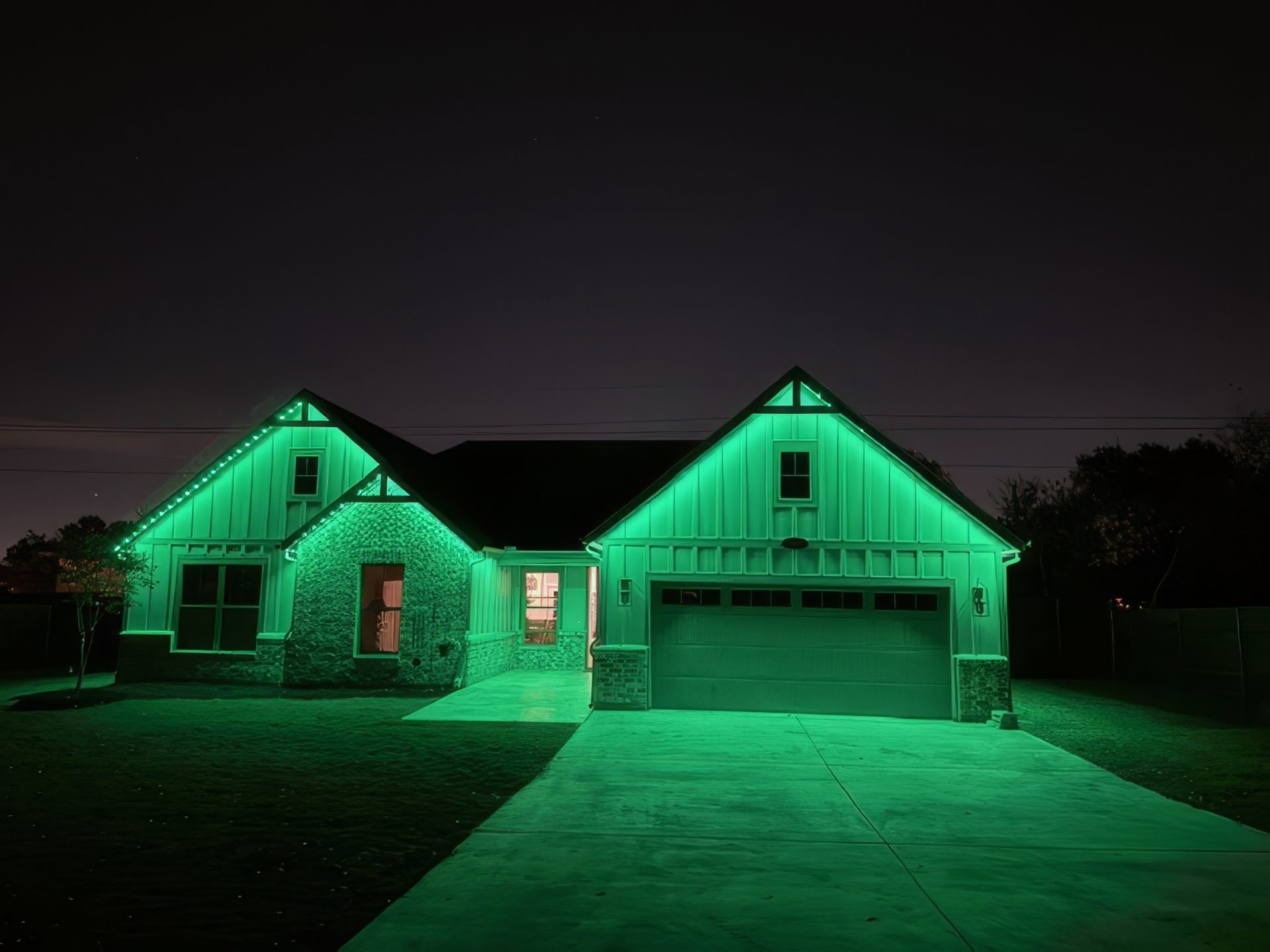 Permanent outdoor holiday lights set to green